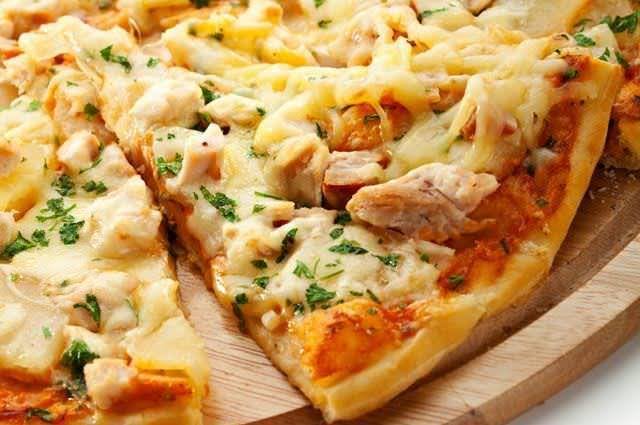 a pizza with cheese and chicken