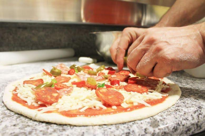 a person making a pizza